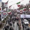 Iran, 40 years of revolution. Iranians march to Azadi (Freedom) Square during the ceremony celebrating the 40th anniversary of the Islamic revolution in the capital Tehran. On the road the flags of Israel and the United States to be trampled in contempt. Tehran, Iran. February 11th 2019.